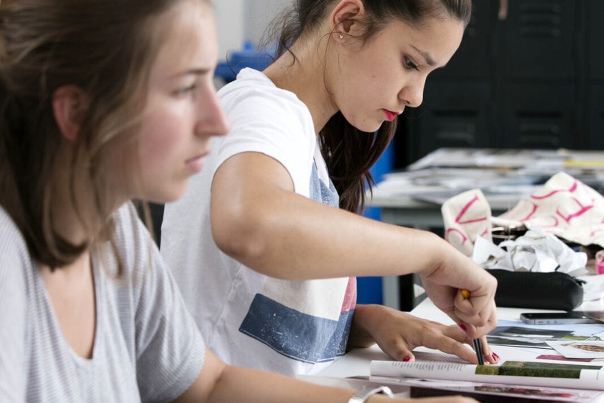 A hands-on creative project taking shape on a shared work table.
